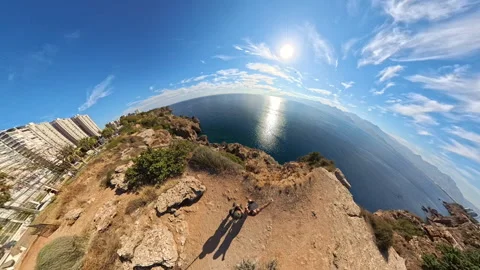 A tiny planet effect image with a woman and man standing on the edge of a cliff Video stock 292463902