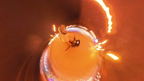 Tiny Planet Effect of Person Riding Motorbike at Night in Tunnel Surrounded by Video stock 310993045