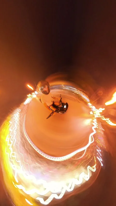Tiny Planet Effect of Person Riding Motorbike at Night in Tunnel Surrounded by Video stock 310993324