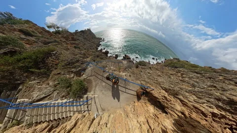 "Tiny planet" effect showing a man and woman at the edge of a cliff by a railing Video stock 294793803