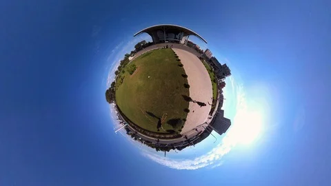 Tiny Planet –  Man watering lawn in Pyongyang- 360° Time lapse Stock Footage 99844053