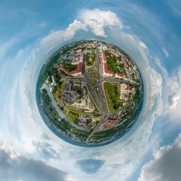 Tiny planet in sky with clouds overlooking old town, urban development, histo Stock Photos