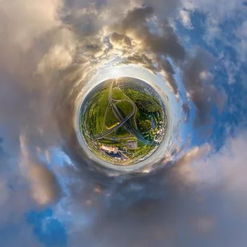 Tiny planet in sky with clouds overlooking old town, urban development, histo Stock Photos