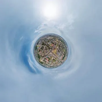 Tiny planet in sky with clouds overlooking old town, urban development, histo Stock Photos