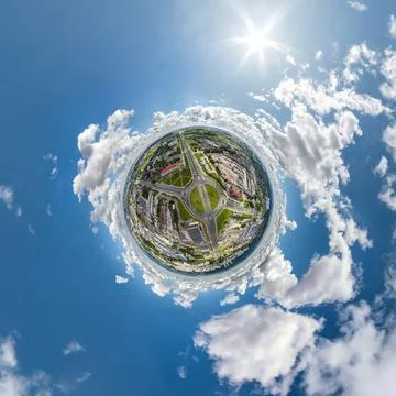 Tiny planet in sky with clouds overlooking old town, urban development, histo Stock Photos