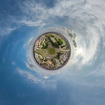 Tiny planet in sky with clouds overlooking old town, urban development, histo Stock Photos