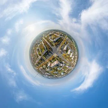 Tiny planet in sky with clouds overlooking old town, urban development, histo Stock Photos