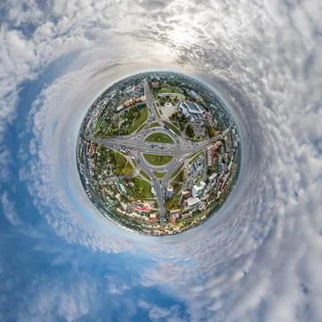 Tiny planet in sky with clouds overlooking old town, urban development, histo Stock Photos