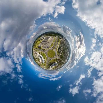 Tiny planet in sky with clouds overlooking old town, urban development, histo Stock Photos
