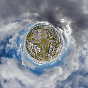 Tiny planet in sky with clouds overlooking old town, urban development, histo Stock Photos