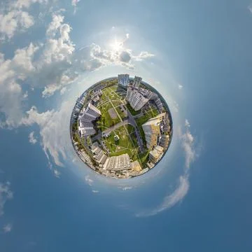 Tiny planet in sky with clouds overlooking old town, urban development, histo Stock Photos