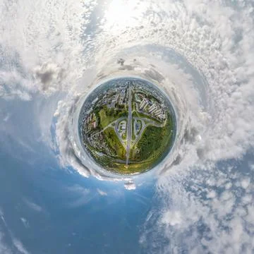 Tiny planet in sky with clouds overlooking old town, urban development, histo Stock Photos