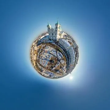 Tiny planet in sky with clouds overlooking old town, urban development, histo Stock Photos