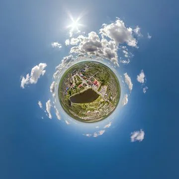 Tiny planet in sky with clouds overlooking old town, urban development, histo Stock Photos