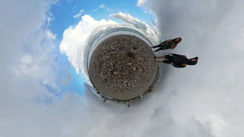 Tiny Planet view of a pebble beach featuring a balanced stone stack at the Vídeos de archivo 293281797