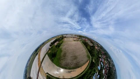 Tiny planet view shows rural landscape with clouds above Vidéo 345395394