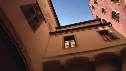 Tiny public patio on the street next to the famous old town hall in Regensburg Stock Footage 306394992