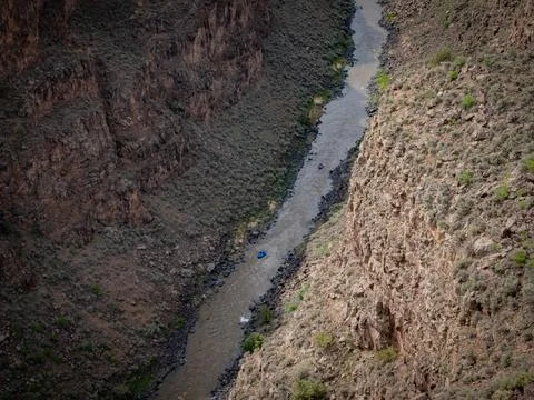 A tiny raft goes down river - Rio Grande Gorge Stock Photos