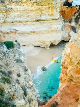 Tiny remote beach in Lagos, Algarve, Portugal. A hidden secret beach between Stock Photos