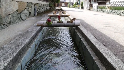 Tiny river running through traditional Japanese Town Stock Footage 93948774
