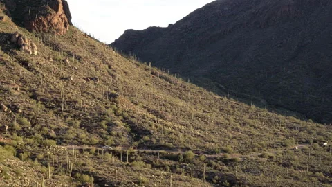 Tiny road with car traffic between big mountains at West Gate Pass Road  Stock Footage 212857389