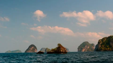 A tiny rock island by a group of islands. 4K Stockbeeldmateriaal 301458984