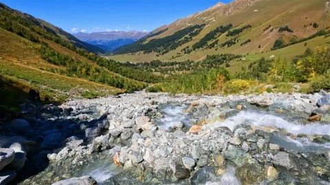 Tiny rocky cute water cascade in Arkhyz mountains at autumn Stock Footage 245133815