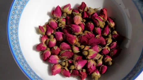 Tiny roses in a saucer with a blue border Stock Footage 23735936