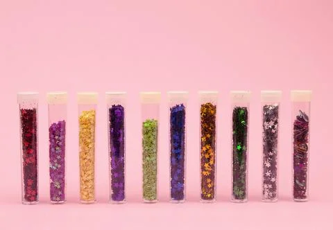 Tiny shimmering sequins in different colors are carefully placed in clear c.. Stock Photos