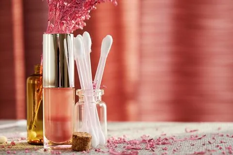 Tiny shiny pink lipstick on the makeup desk in the fashion shop Stock Photos