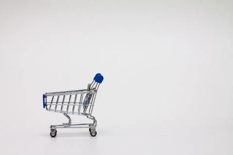 A tiny shopping cart on isolated background Stock Photos