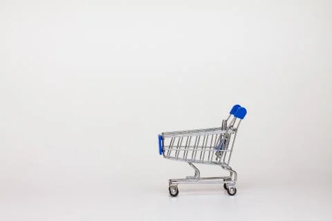 A tiny shopping cart on isolated background Stock Photos