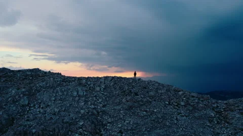 Tiny silhouette of man walk on mountain ridge Video stock 220834799