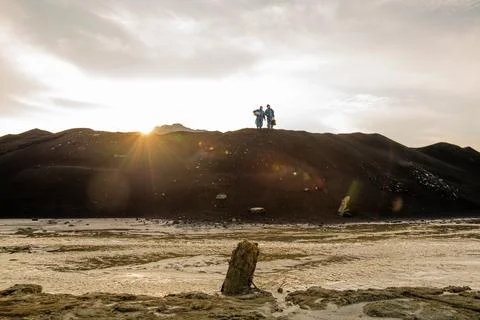 Tiny silhouettes of contemporary researchers standing on hilltop with polluted Stock Photos