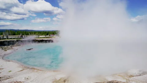 Tiny silhouettes of tourists observing misty volcanic spring in Yellowstone park Stock Footage 272404671