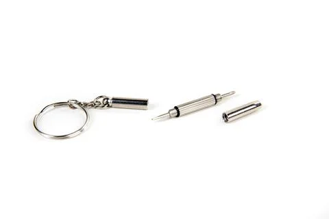 Tiny silver screwdriver keychain eyeglass kit in pieces side view Stock Photos
