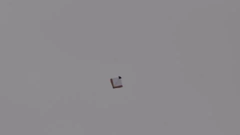 Tiny single kite flying alone Stock Footage 320016333