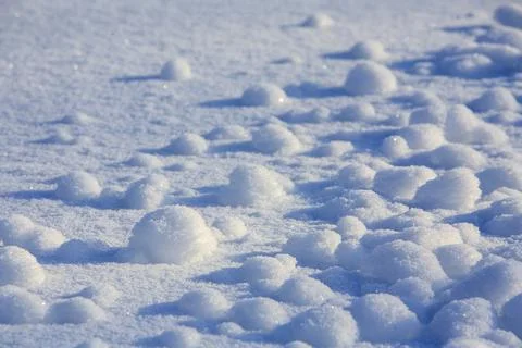 Tiny snowballs on snow surface at Winter, Finland Stockfoto's