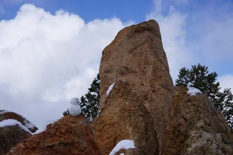 Tiny Snowman next to Large Rock Stock Photos