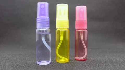 Tiny spray bottles of various colors Stock Photos