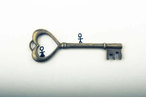 Tiny stick man and  a  retro style heart shaped key as love concept Foto stock