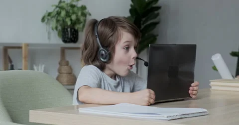 Tiny surprised overjoyed school kid won in a computer game or successfully Video stock 162477624