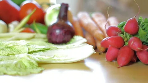 Tiny tomatoes falling on the salad leaves, dolly shot, shot at 60fps Video stock 777478