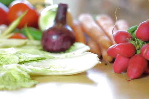 Tiny tomatoes falling on the salad leaves, dolly shot, shot at 60fps Video stock 777479
