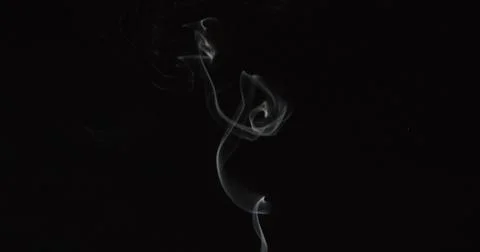 Tiny trail of smoke over dark background 2 Stock Photos