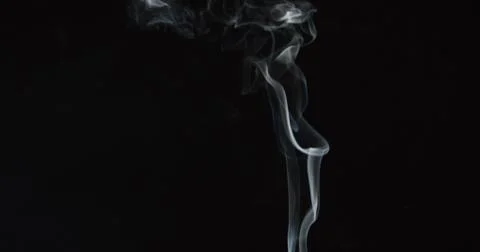 Tiny trail of smoke over dark background 1 Stock Photos