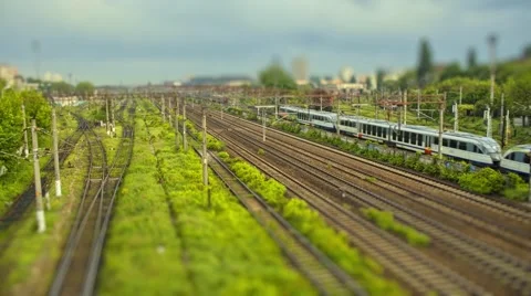 Tiny trains passing on different tracks - tilt-shift time lapse Stock Footage 63099660