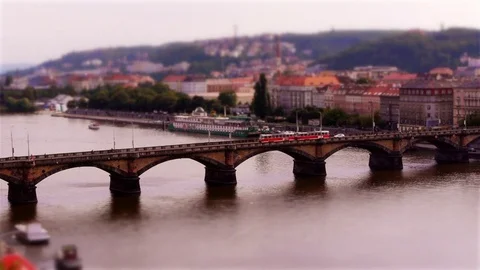 Tiny Trams crossing bridge in Prague (Tilt-shift) Stock Footage 82707447