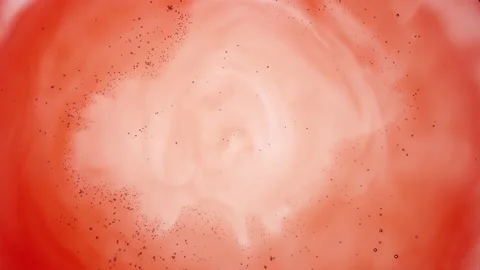 Tiny transparent grey bubbles move to the center of red fluid 库存影片 154460403