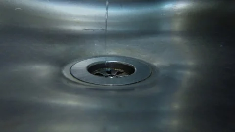 Tiny turbulence in the sink drain Stock Footage 97328569